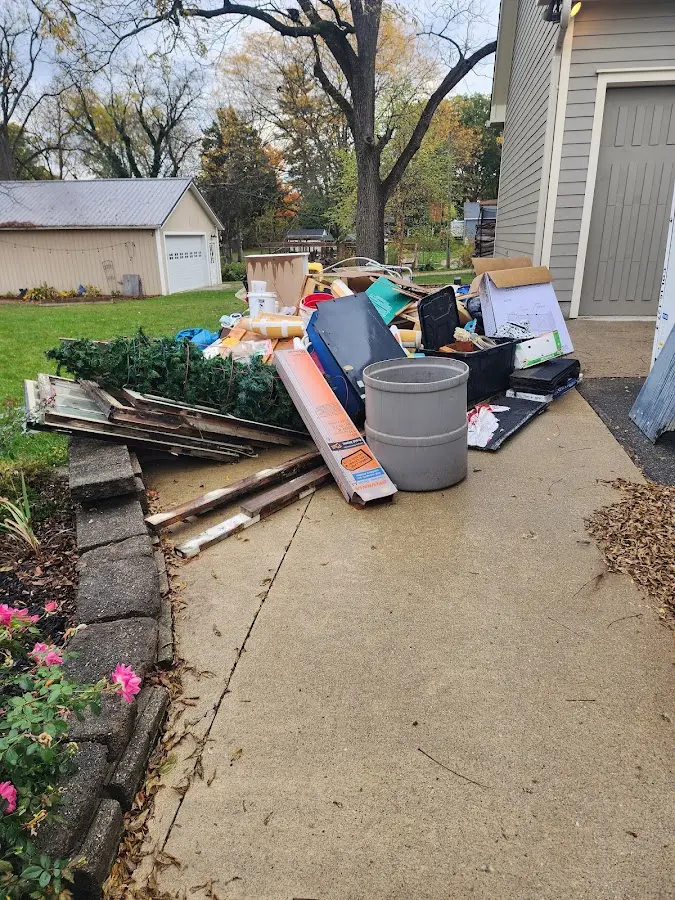 Dumpster being loaded with debris for Roofing Dumpster Rental in Richland